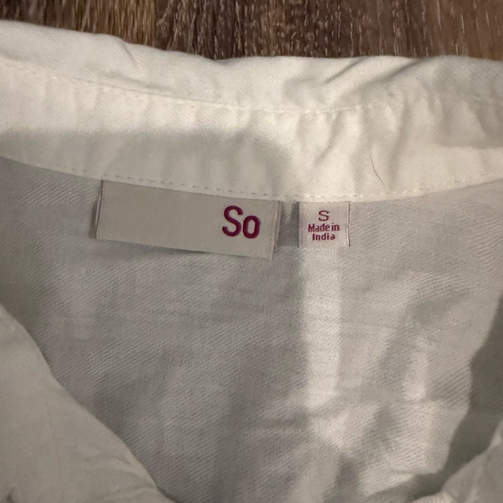 Small white sleeveless button up shirt